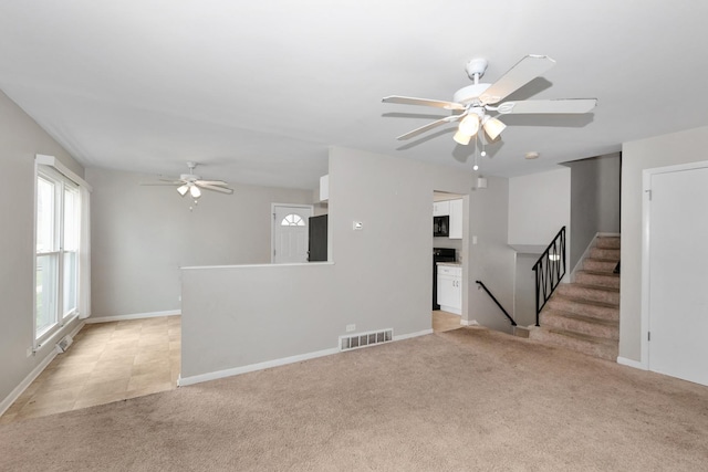 742 Newell Ave, Calumet City, IL 60409 - unfurnished living room featuring stairway, visible vents, ceiling fan, baseboards, and light carpet