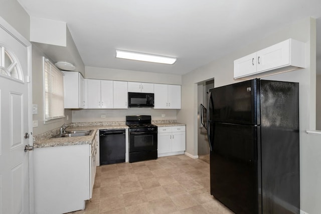 742 Newell Ave, Calumet City, IL 60409 - kitchen with white cabinets, a sink, light countertops, baseboards, and black appliances