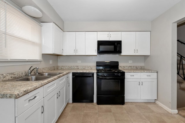 742 Newell Ave, Calumet City, IL 60409 - kitchen with baseboards, light countertops, black appliances, a sink, and white cabinetry