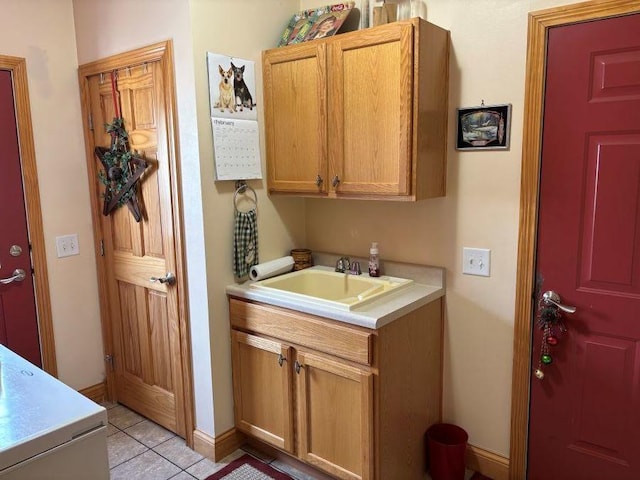 bathroom featuring baseboards, tile patterned floors, and vanity