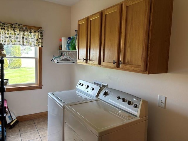 washroom featuring cabinet space, independent washer and dryer, baseboards, and light tile patterned floors