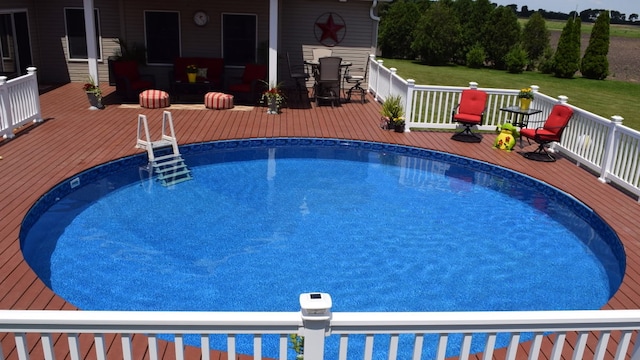 outdoor pool with a wooden deck
