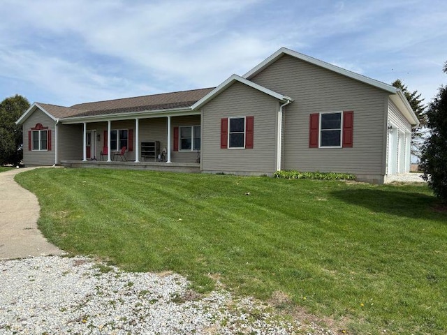 view of front of home with a porch, an attached garage, and a front yard