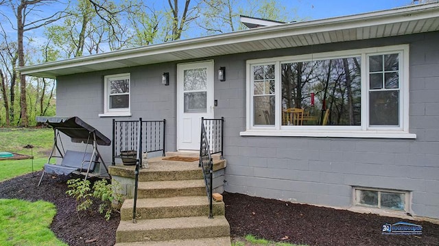 property entrance featuring concrete block siding