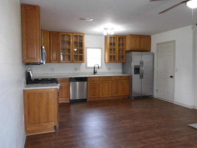 908 Merrill Ave, Loves Park, IL 61111 - kitchen with brown cabinets, dark wood-type flooring, stainless steel appliances, and a sink