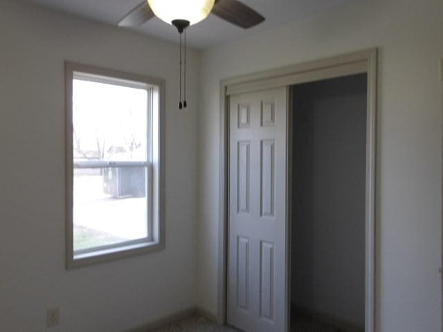 908 Merrill Ave, Loves Park, IL 61111 - unfurnished bedroom with a closet and ceiling fan