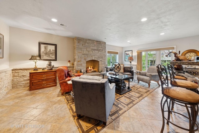 21819 W Riviera Ct, Mundelein, IL 60060 - living area with recessed lighting, a stone fireplace, and light tile patterned floors