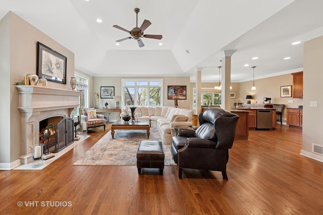 21819 W Riviera Ct, Mundelein, IL 60060 - living room with wood finished floors, ornate columns, ceiling fan, a fireplace with flush hearth, and recessed lighting