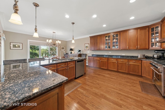 21819 W Riviera Ct, Mundelein, IL 60060 - kitchen featuring crown molding, appliances with stainless steel finishes, brown cabinetry, and a sink
