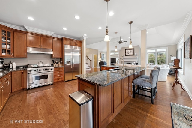 21819 W Riviera Ct, Mundelein, IL 60060 - kitchen with a sink, ceiling fan, brown cabinetry, and high end appliances