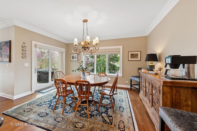 21819 W Riviera Ct, Mundelein, IL 60060 - dining room featuring a chandelier, ornamental molding, baseboards, and wood finished floors