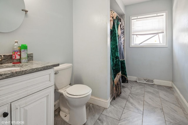 full bathroom with toilet, vanity, visible vents, and baseboards