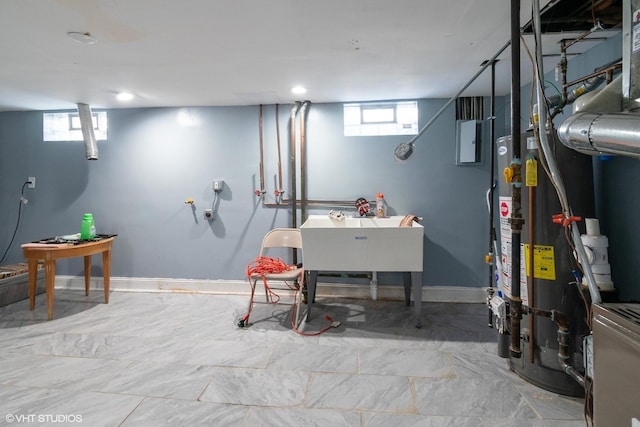 basement with electric panel, baseboards, and a sink