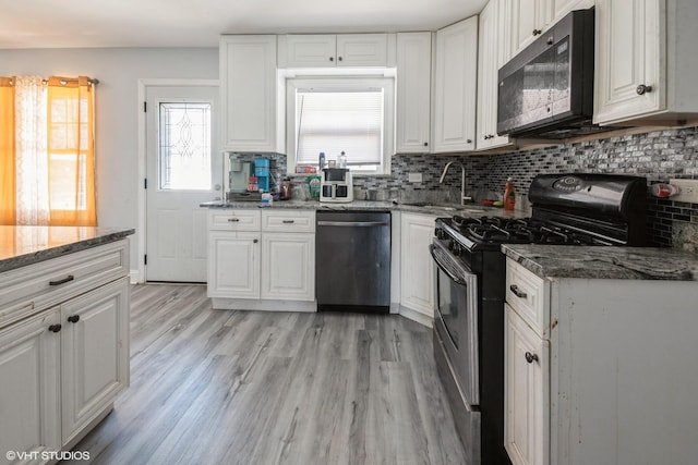 kitchen with white cabinetry, backsplash, appliances with stainless steel finishes, and a healthy amount of sunlight