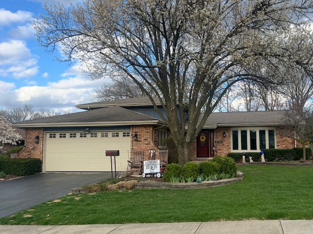 1127 Alpine Ln, Lemont, IL 60439 - view of front of house featuring an attached garage, a front lawn, brick siding, and aphalt driveway