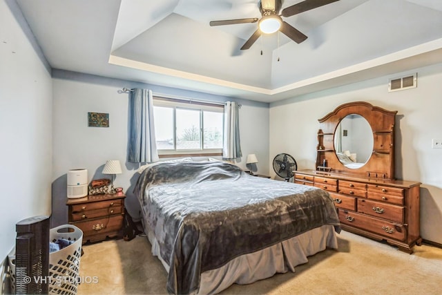 1127 Alpine Ln, Lemont, IL 60439 - bedroom with visible vents, ceiling fan, a tray ceiling, and light carpet