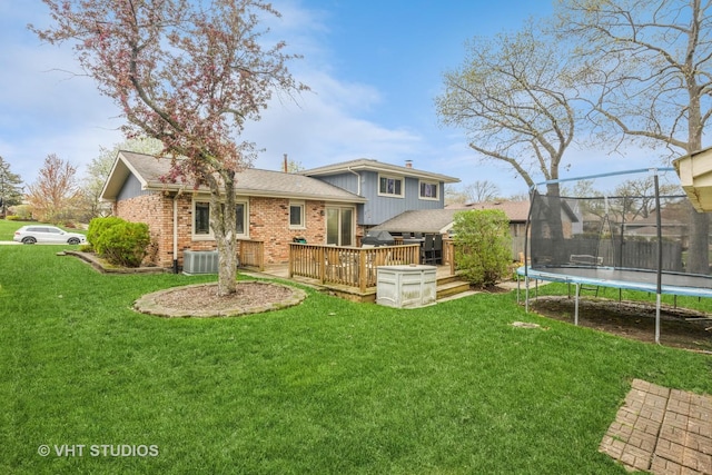 1127 Alpine Ln, Lemont, IL 60439 - rear view of house featuring a lawn, a deck, central AC unit, and a trampoline