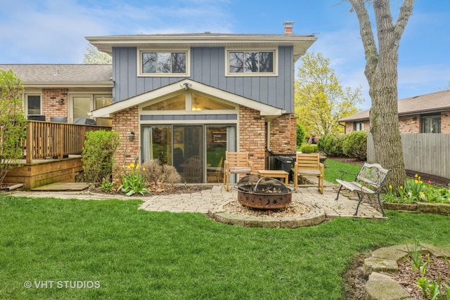 1127 Alpine Ln, Lemont, IL 60439 - rear view of house featuring a fire pit, fence, brick siding, a patio area, and a lawn