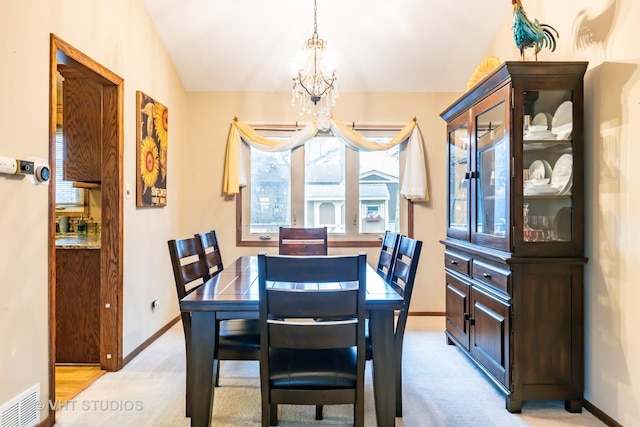 1127 Alpine Ln, Lemont, IL 60439 - dining room with baseboards, visible vents, light colored carpet, and a notable chandelier