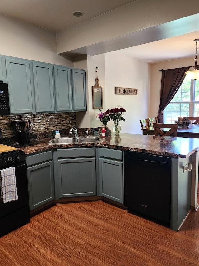 119 Oak Knoll Ct, Volo, IL 60020 - kitchen featuring black appliances, a sink, a peninsula, tasteful backsplash, and wood finished floors