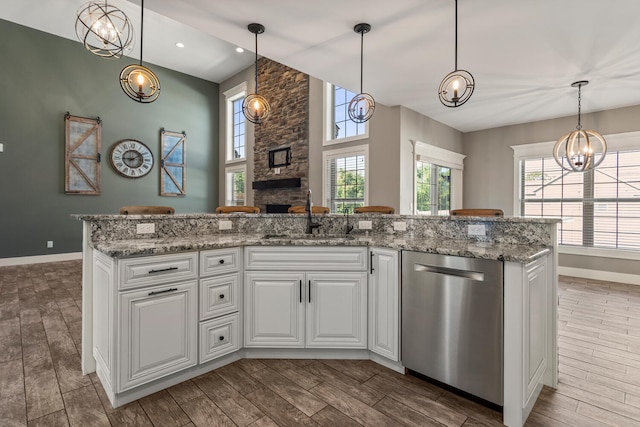 1101 Cascade Dr, Savoy, IL 61874 - kitchen featuring dishwasher, a fireplace, healthy amount of natural light, wood tiled floors, and recessed lighting