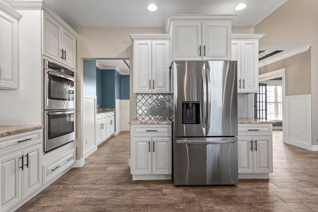1101 Cascade Dr, Savoy, IL 61874 - kitchen with stainless steel appliances, dark wood-type flooring, recessed lighting, backsplash, and ornamental molding