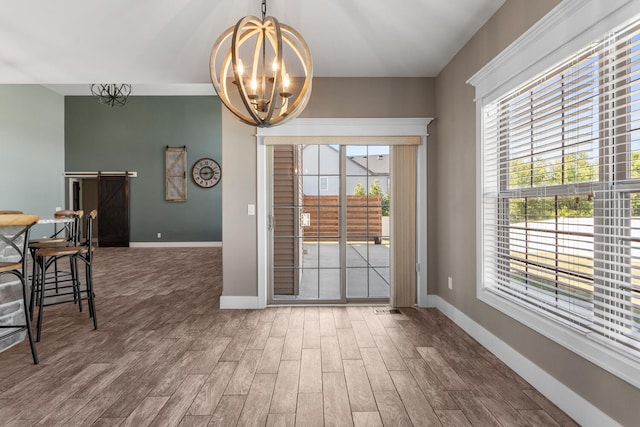 1101 Cascade Dr, Savoy, IL 61874 - dining room with wood finished floors and a chandelier