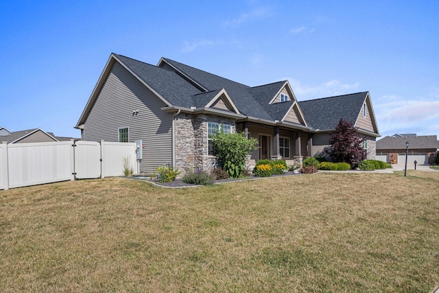 1101 Cascade Dr, Savoy, IL 61874 - view of side of home with a gate, stone siding, and roof with shingles