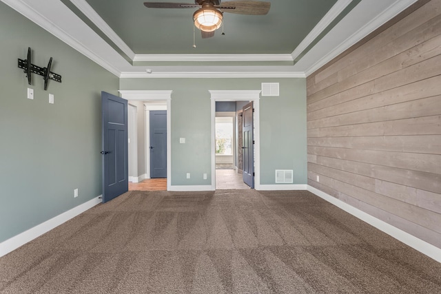 1101 Cascade Dr, Savoy, IL 61874 - unfurnished bedroom with a tray ceiling, carpet flooring, wood walls, crown molding, and ensuite bath