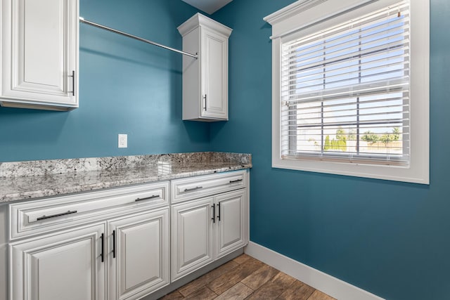 1101 Cascade Dr, Savoy, IL 61874 - laundry room with dark wood-style floors and baseboards