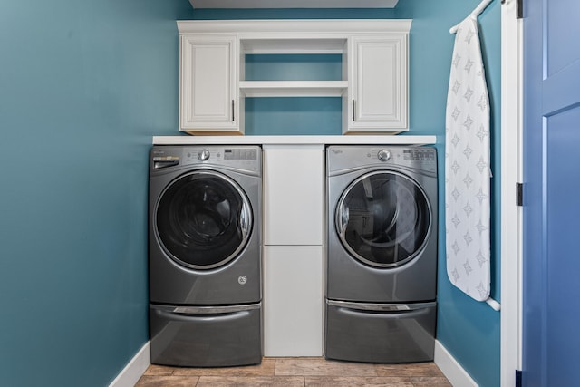 1101 Cascade Dr, Savoy, IL 61874 - laundry room featuring independent washer and dryer and cabinet space