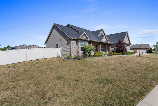 1101 Cascade Dr, Savoy, IL 61874 - view of front facade featuring stone siding, a gate, and a shingled roof