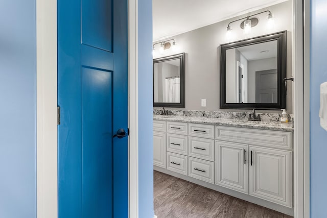1101 Cascade Dr, Savoy, IL 61874 - bathroom featuring double vanity and wood finished floors