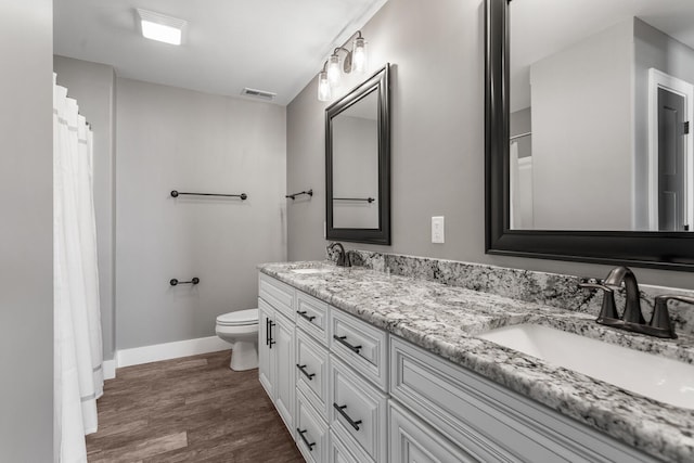 1101 Cascade Dr, Savoy, IL 61874 - bathroom with double vanity, wood finished floors, and a shower with curtain