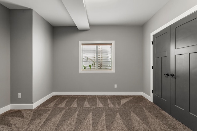 1101 Cascade Dr, Savoy, IL 61874 - unfurnished bedroom featuring dark carpet and a closet