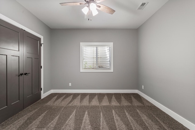 1101 Cascade Dr, Savoy, IL 61874 - unfurnished bedroom with dark colored carpet and a ceiling fan