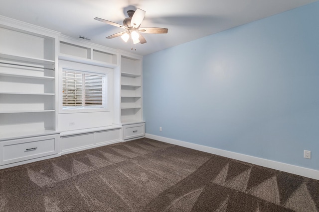 1101 Cascade Dr, Savoy, IL 61874 - unfurnished bedroom with dark carpet and ceiling fan