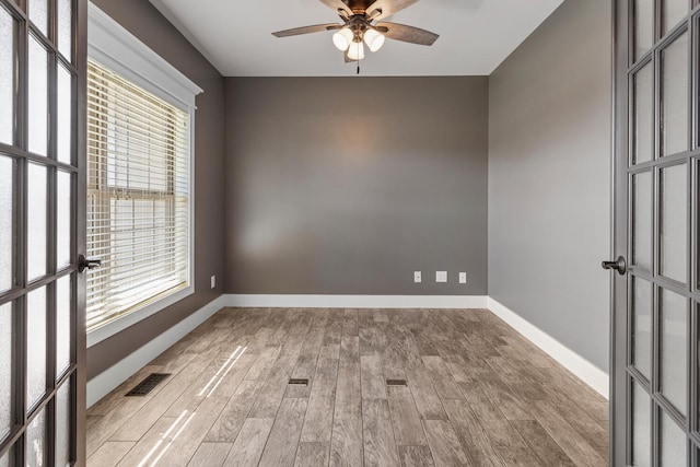 1101 Cascade Dr, Savoy, IL 61874 - spare room with healthy amount of natural light, ceiling fan, and wood finished floors