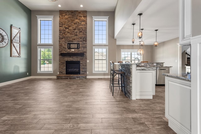 1101 Cascade Dr, Savoy, IL 61874 - kitchen featuring a fireplace, a kitchen breakfast bar, dark wood-style floors, dishwasher, and recessed lighting
