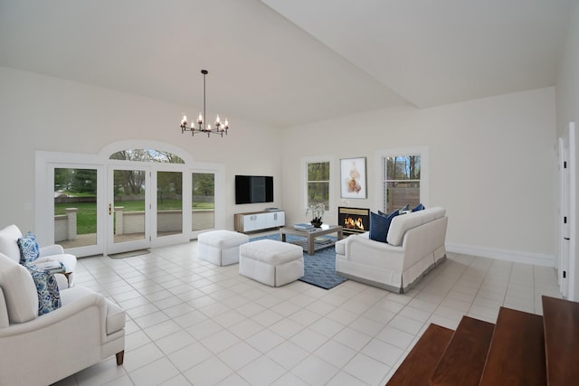 1005 Hovey Ave, Normal, IL 61761 - living area with a lit fireplace, baseboards, an inviting chandelier, and light tile patterned floors