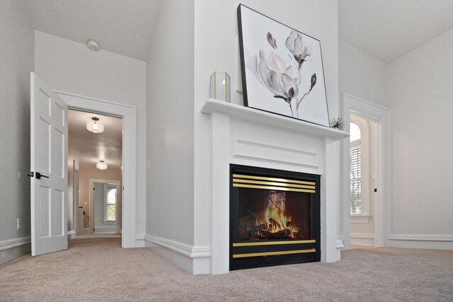1005 Hovey Ave, Normal, IL 61761 - details featuring a glass covered fireplace, carpet, and baseboards