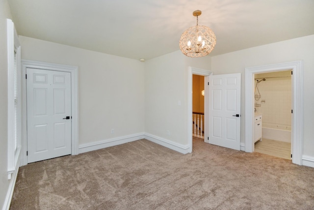 1005 Hovey Ave, Normal, IL 61761 - unfurnished bedroom featuring an inviting chandelier, ensuite bath, baseboards, and carpet floors