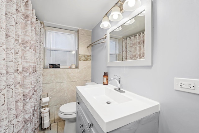 full bathroom featuring vanity, a shower with curtain, toilet, and tile walls