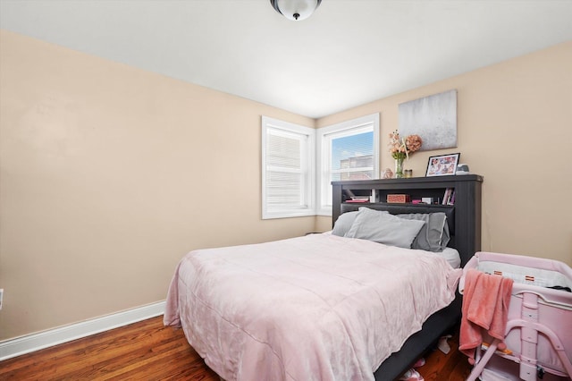 bedroom with baseboards and wood finished floors