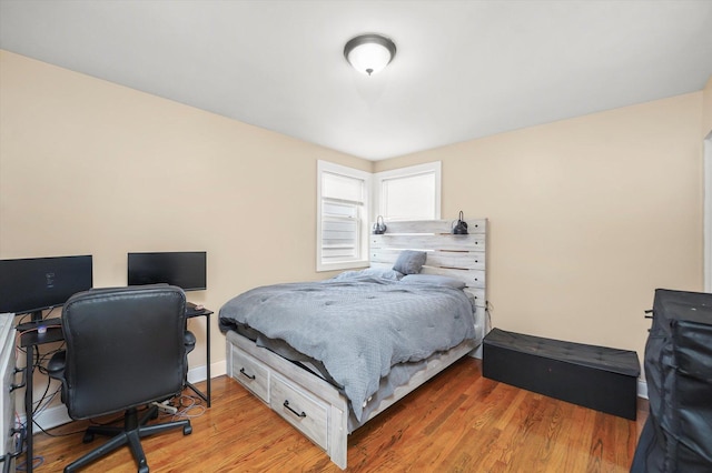 bedroom featuring light wood-style floors and baseboards
