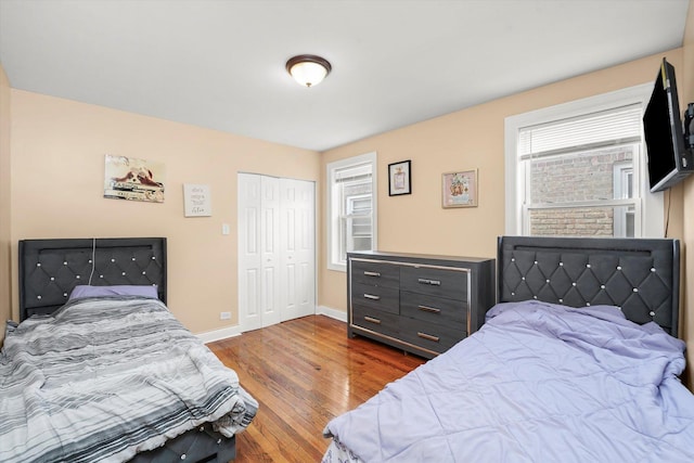 bedroom featuring baseboards, a closet, and wood finished floors