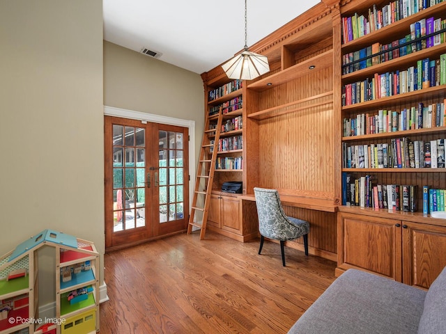 office featuring french doors, wood finished floors, and visible vents