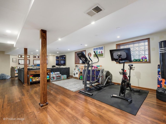 exercise area with baseboards, recessed lighting, wood finished floors, and visible vents