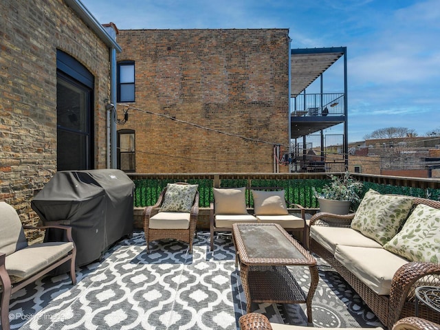 view of patio / terrace featuring grilling area, an outdoor living space, and a balcony