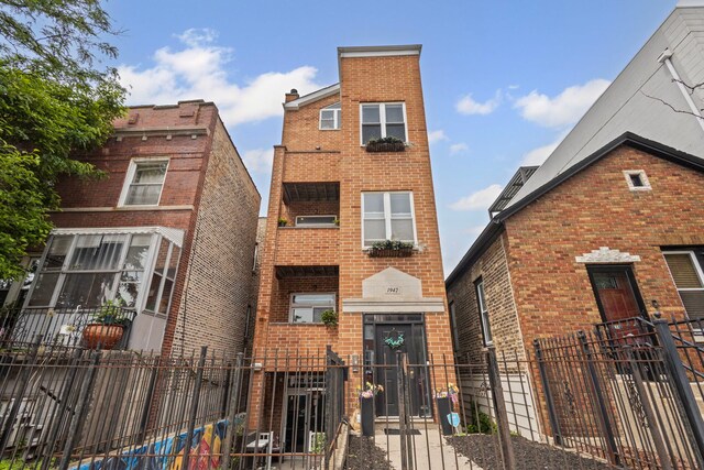 1942 W Armitage Ave Unit 2, Chicago, IL 60622 - view of front of house featuring brick siding and a fenced front yard